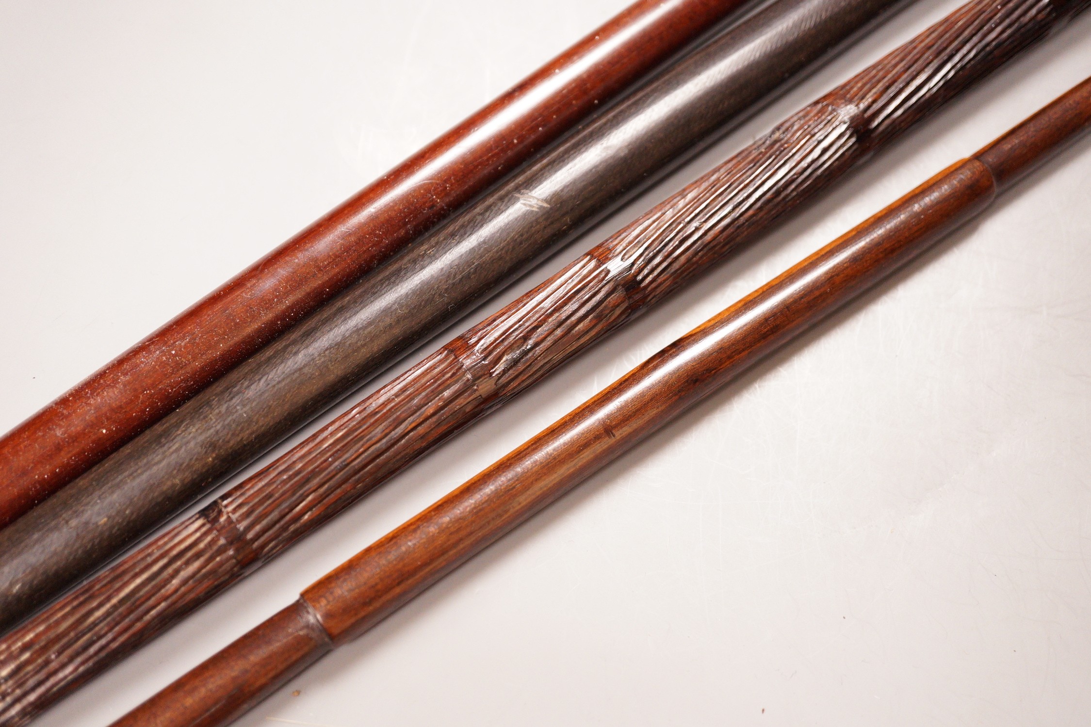 Two various hardwood canes, an ebony spear and a horn tool, longest 111cm
